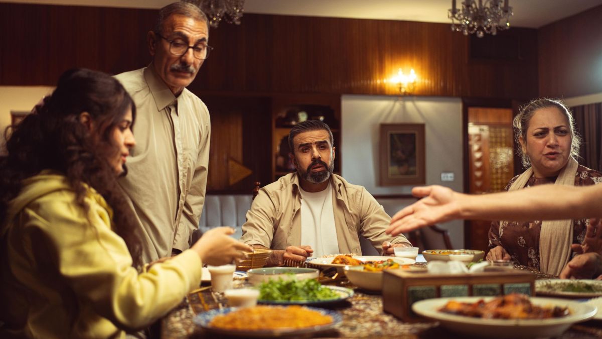 A multi-generational family enjoying a meal together in a warm, inviting indoor setting.