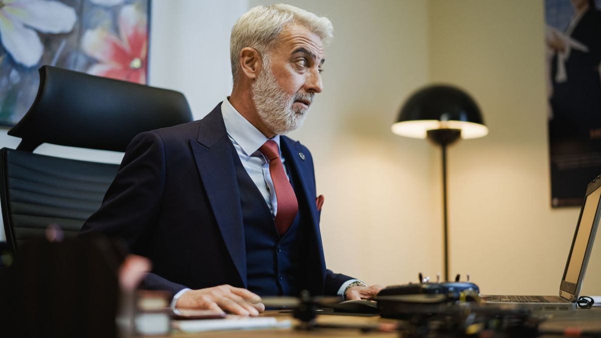 Senior businessman at his office desk, focused on work, with a stylish modern setup.