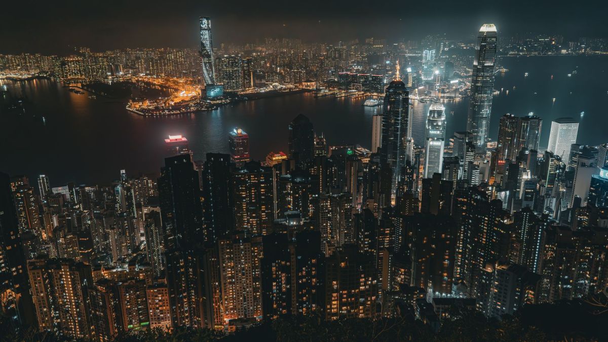 Breathtaking aerial view of Hong Kong skyline at night with Victoria Harbour lights.
