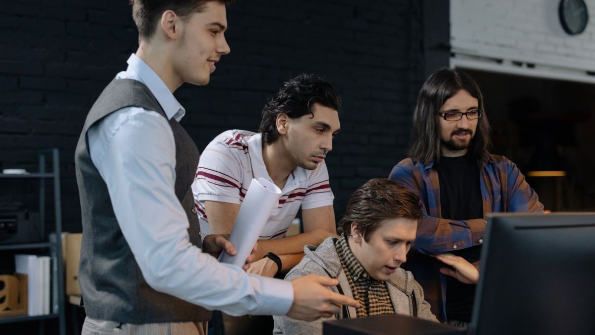 Group of young professionals collaborating on a project in a modern office environment.