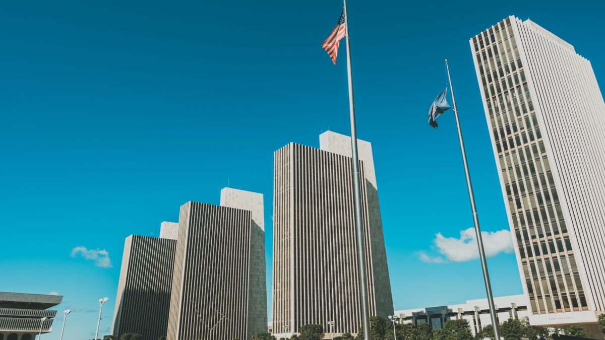 Modern skyscrapers towering at Empire State Plaza in Albany, New York under a clear blue sky.
