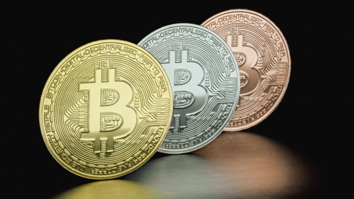 Close-up of Bitcoin coins in gold, silver, and bronze hues depicting cryptocurrency variety.