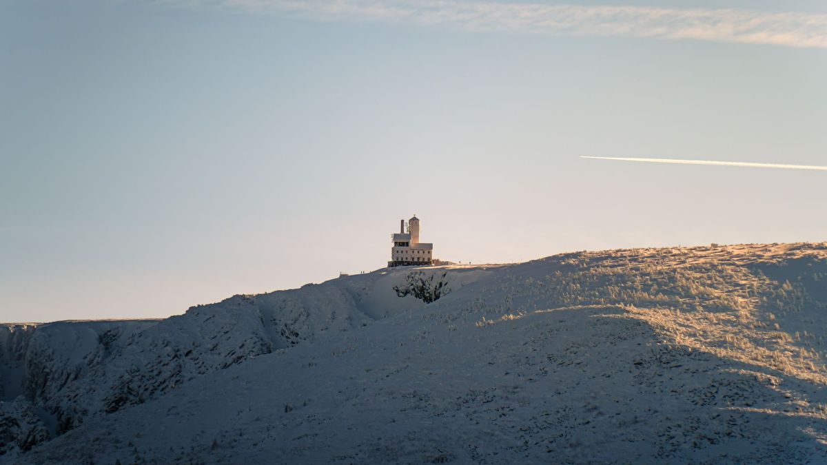 A stunning view of the Sniezne Kotly Observatory in Karkonosze National Park during sunrise.