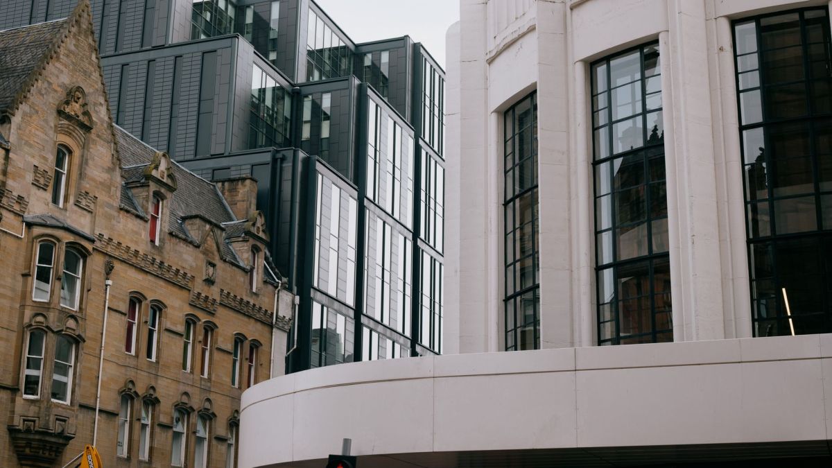 A blend of modern and Victorian architecture in Glasgow, Scotland, showcasing urban contrast.