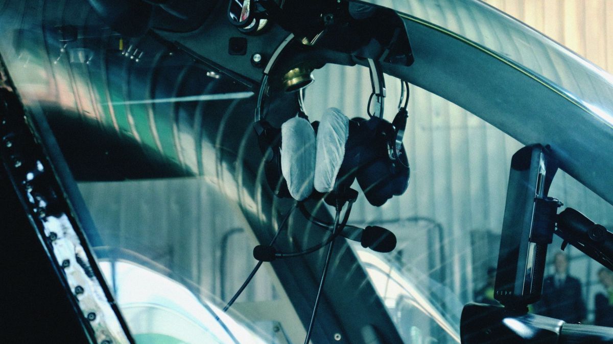 Close-up of helicopter cockpit interior showcasing navigation equipment and headphones.