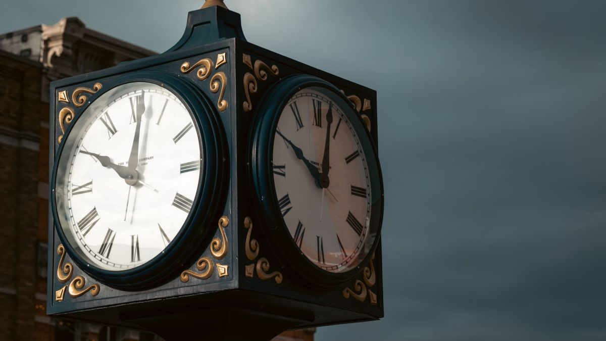 Elevate spaces with a classic outdoor clock displaying Roman numerals against a moody sky backdrop.