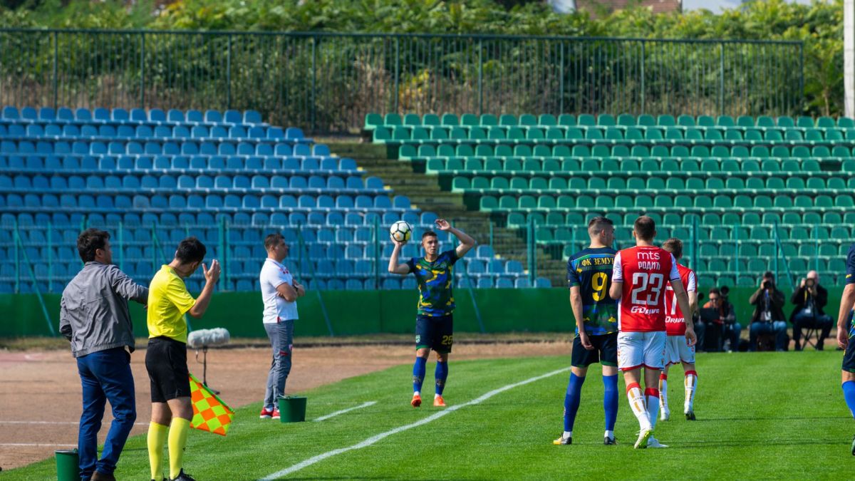 Soccer players in action during a lively match at an outdoor stadium.
