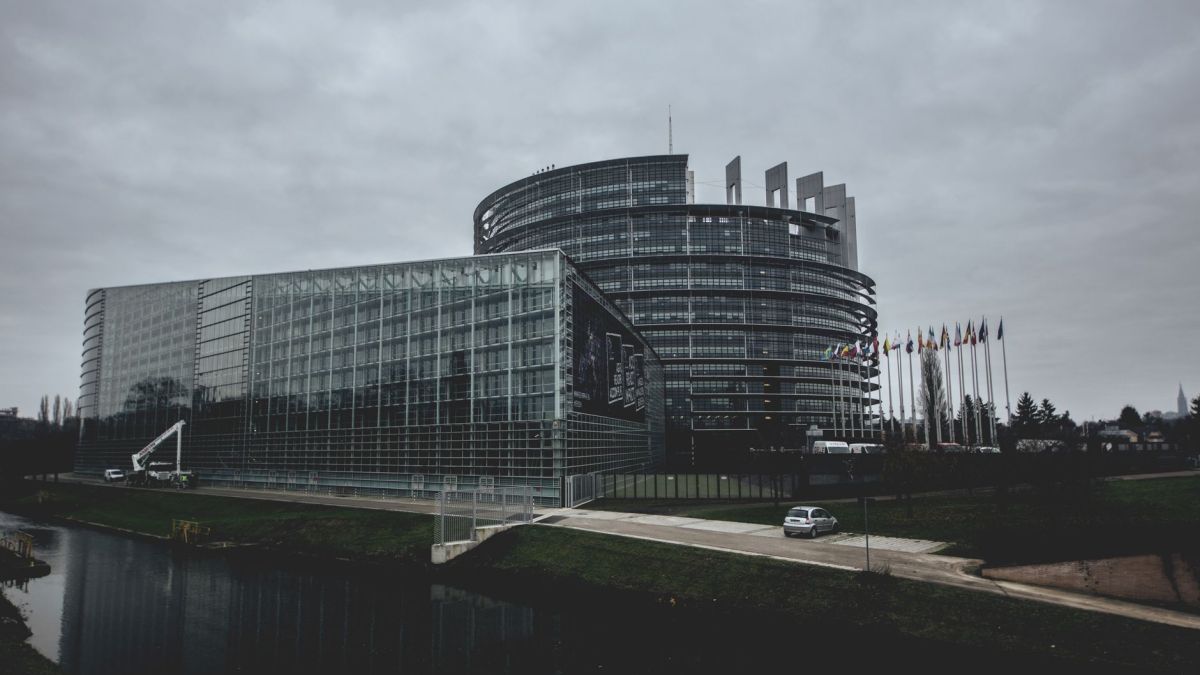 Modern architecture of the European Parliament in Strasbourg on a cloudy day.