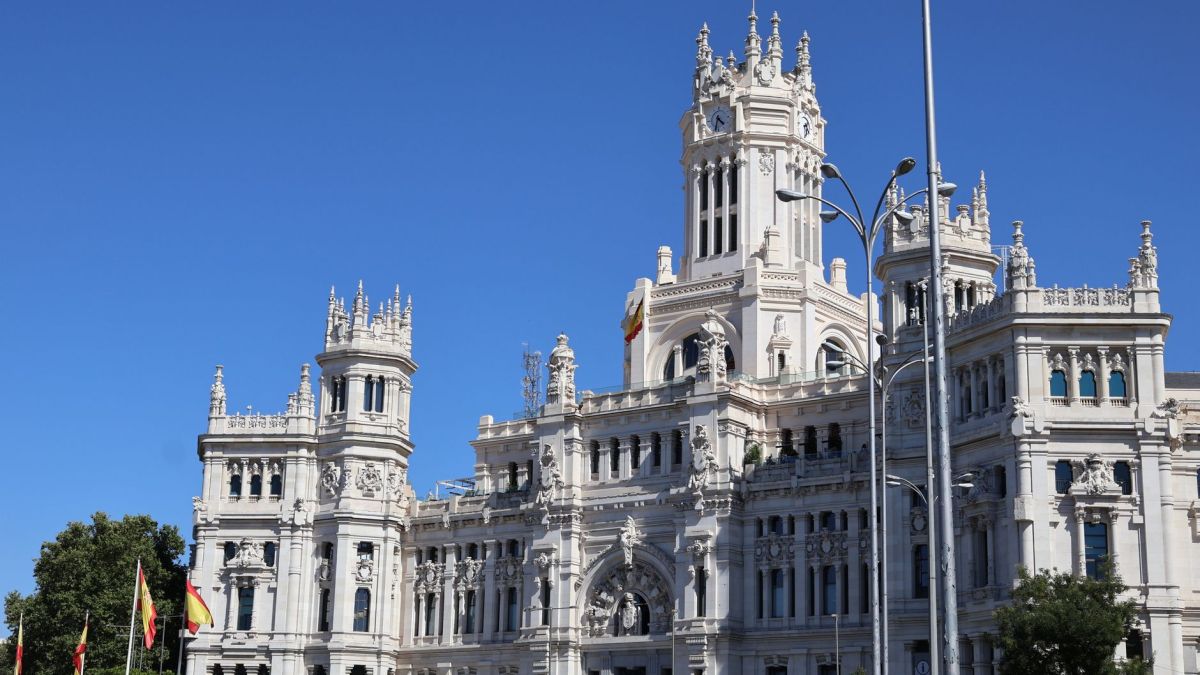 Stunning view of Palacio de Cibeles, a landmark in Madrid, Spain, under a clear blue sky.