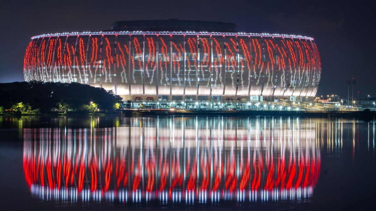 Lusail Stadium beautifully illuminated with reflections on water during night in Qatar.