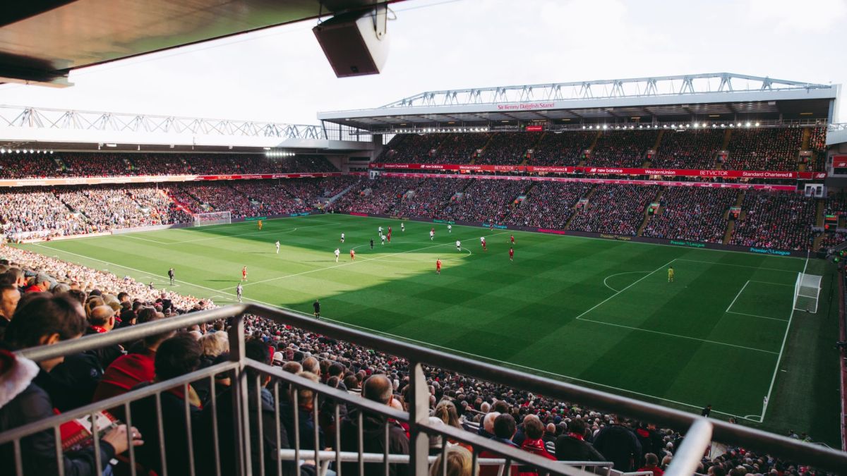 A vibrant soccer game with a full crowd in a modern stadium, capturing the energy of the sport.