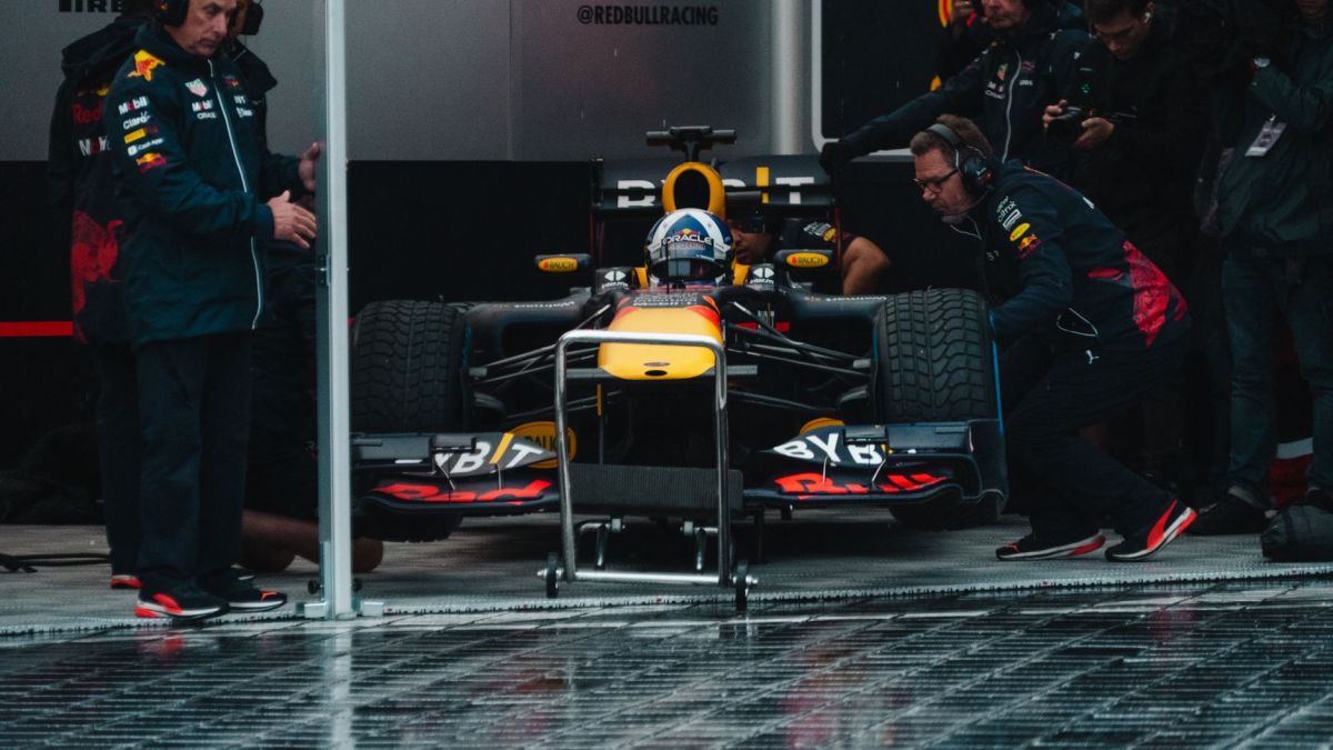 Red Bull Racing pit crew readying the Formula 1 car during an intense race event.