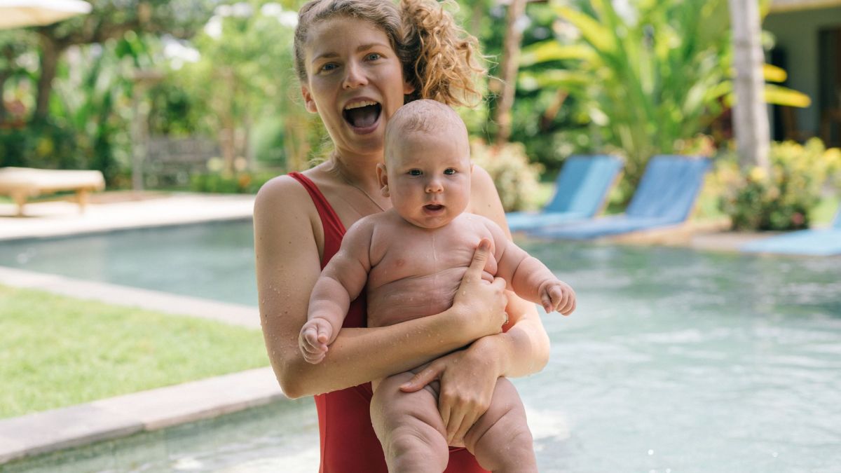 Joyful mother and baby enjoying a fun day by the pool. Perfect summer family moment.
