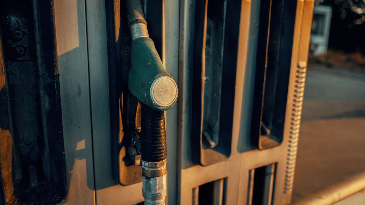 A detailed view of a gas pump nozzle during sunset in Österreich, highlighting industrial design.