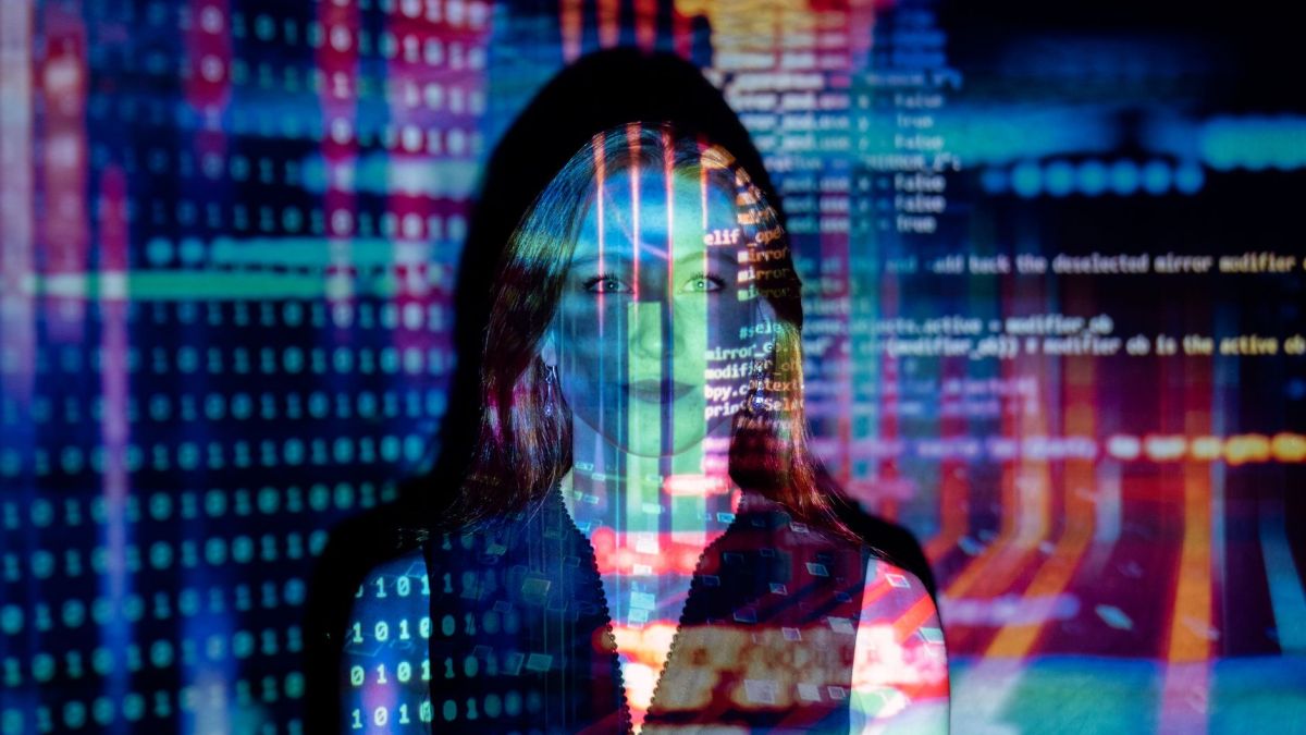 A woman with digital code projections on her face, representing technology and future concepts.