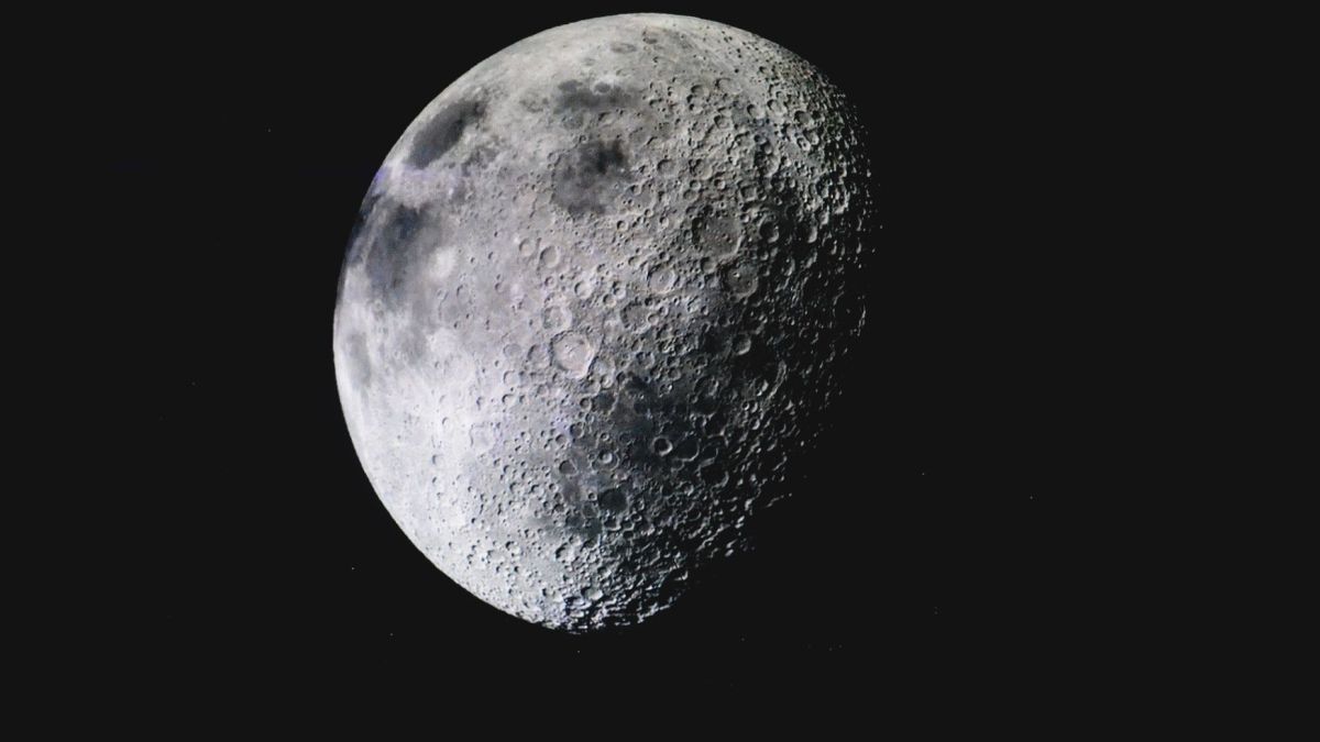 Captivating image of the lunar surface with visible craters against a deep dark sky.