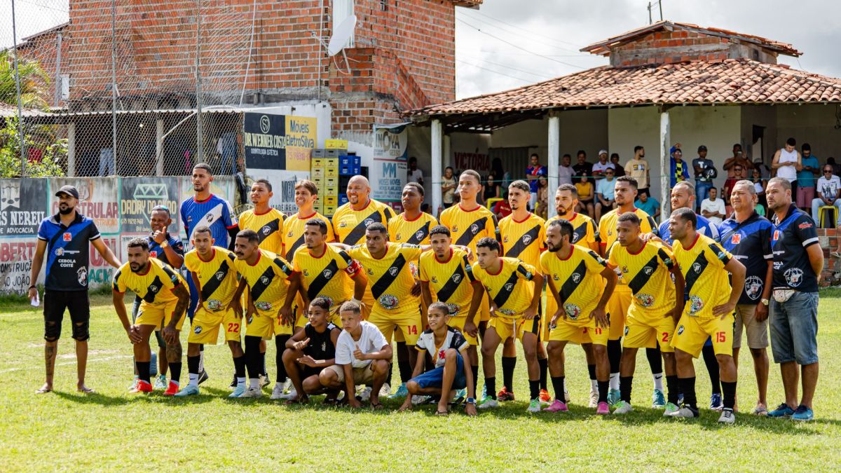 Local amateur football team poses for a group photo before starting their match.