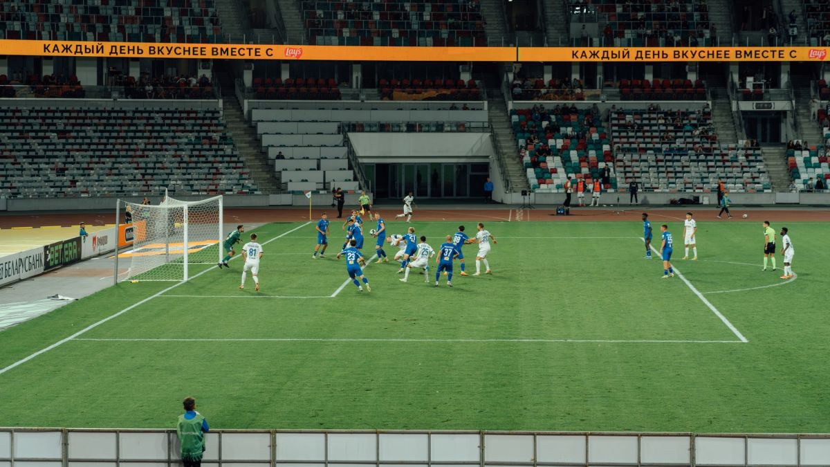 A thrilling football game captured in a large, modern stadium at night.