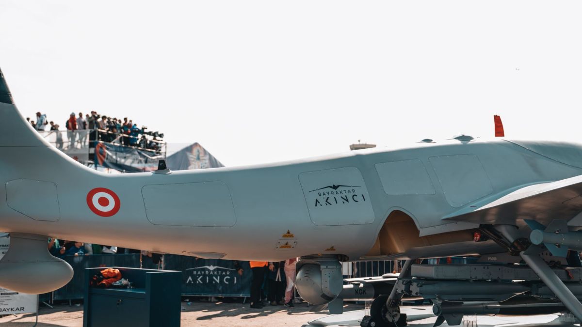 Bayraktar Akinci drone displayed at a busy airshow with spectators.