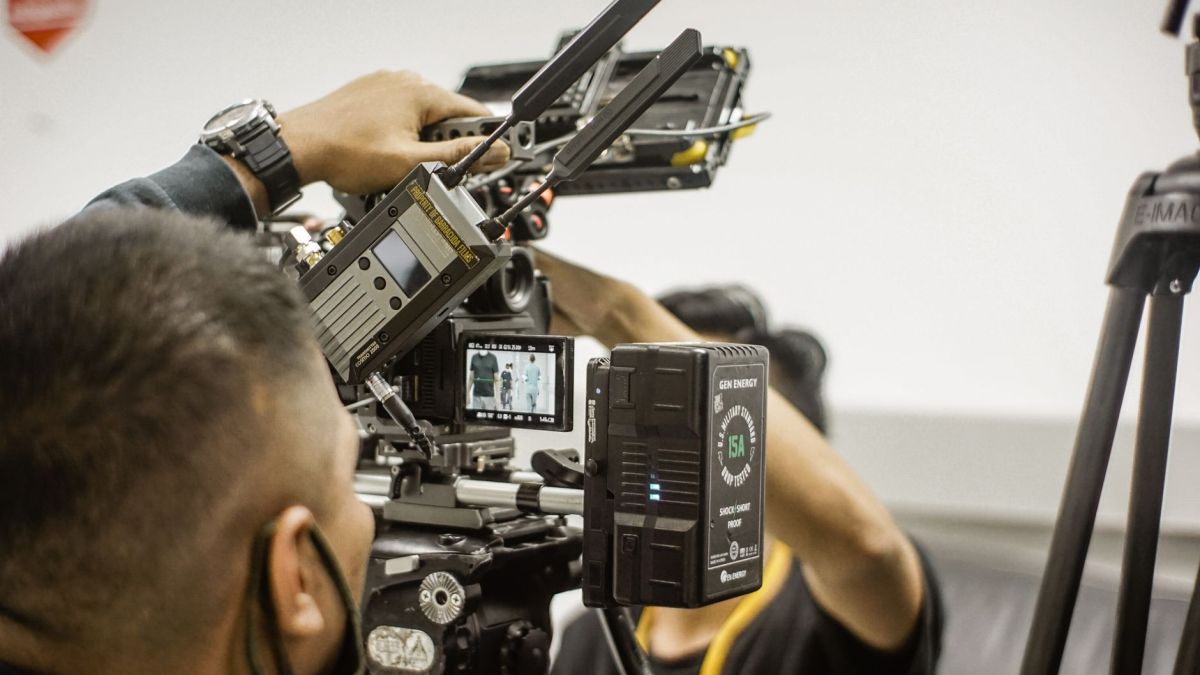 Close-up of advanced filmmaking equipment being used by professionals indoors.