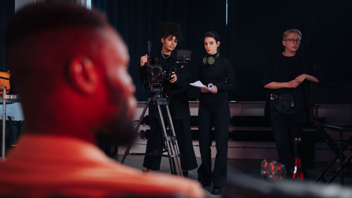 Film crew setting up cameras and equipment during a production.