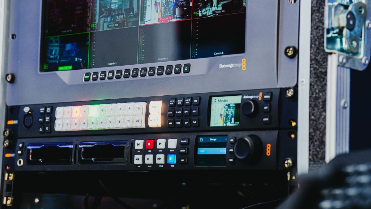 Close-up of advanced video editing equipment featuring multiple screens and control panels.