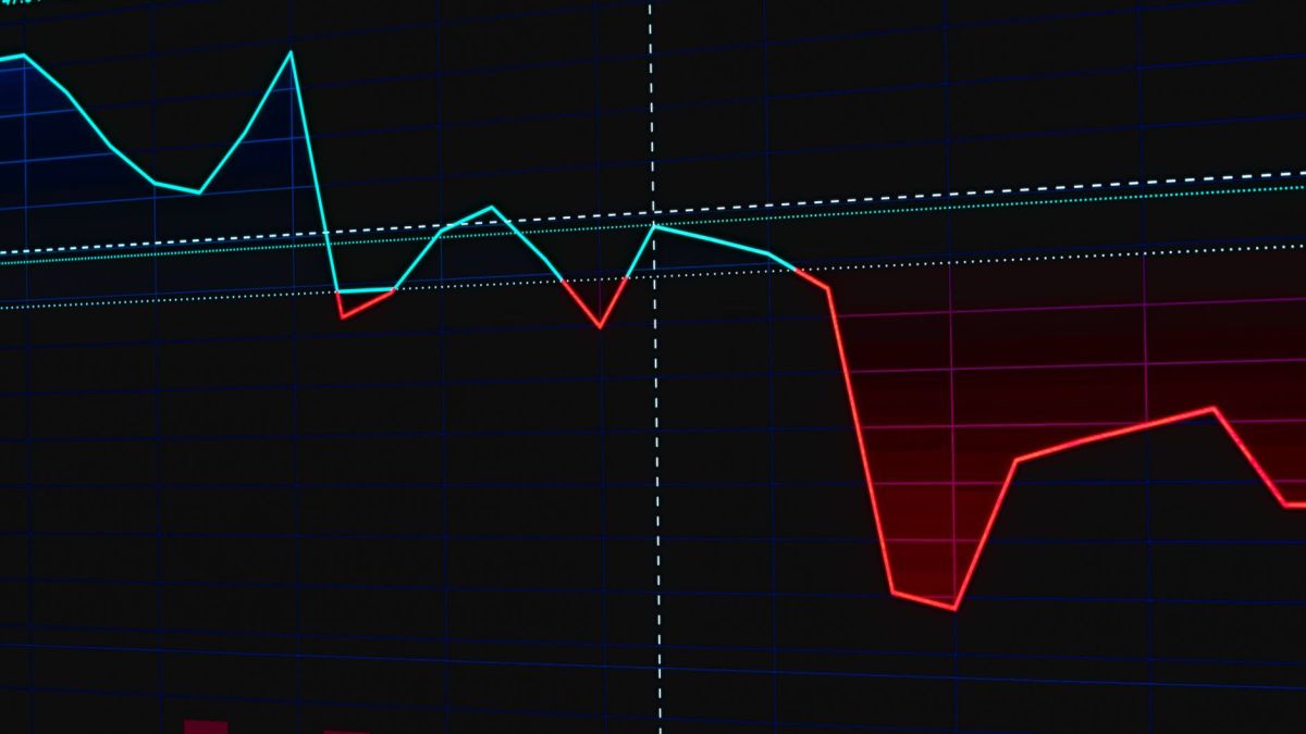 Visual representation of a fluctuating stock market chart with red and green lines.