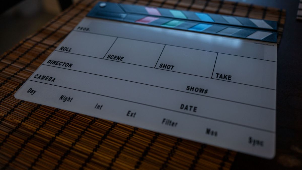 Close-up of a film clapperboard on a bamboo mat, ideal for filmmaking concepts.