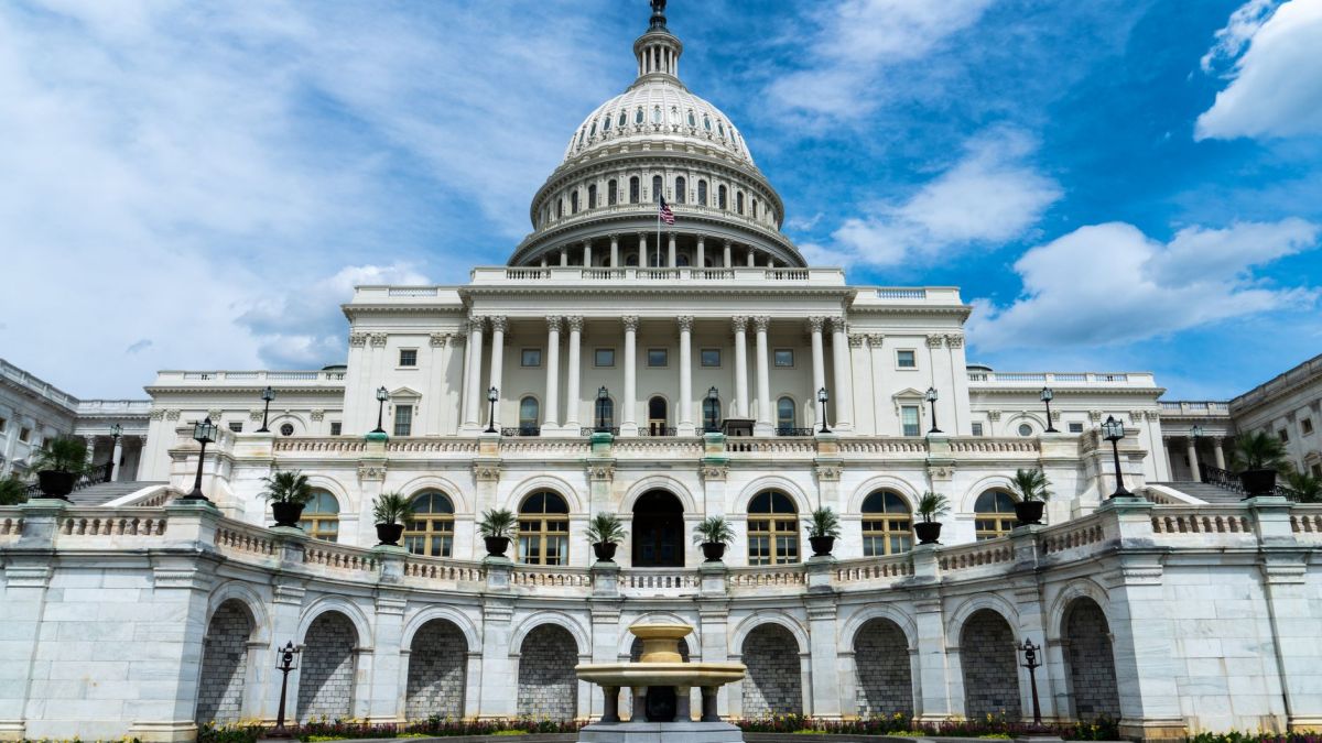 Exterior view of the iconic US Capitol Building on a sunny day in Washington, DC.