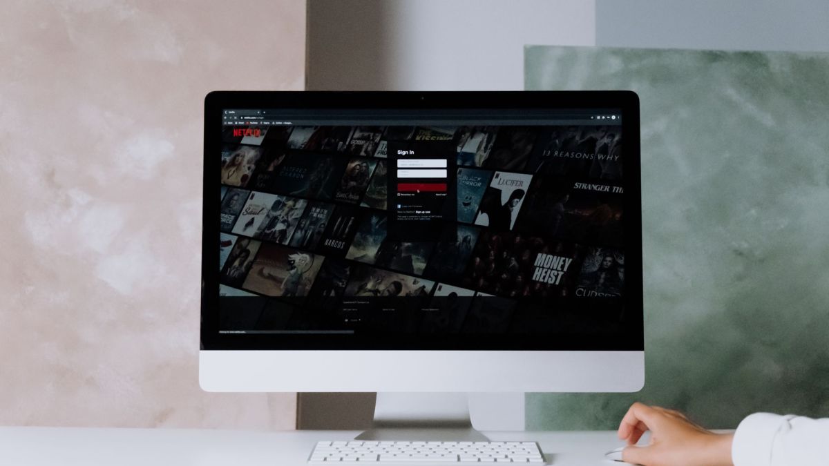 A modern desktop displays a streaming service interface, showcasing entertainment options in a minimalist office setting.