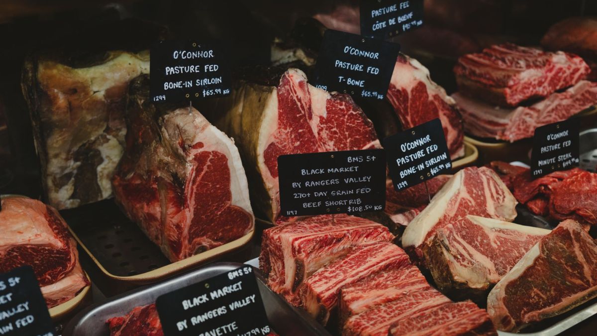 Assorted premium beef cuts with labels showcased in a gourmet market setting.