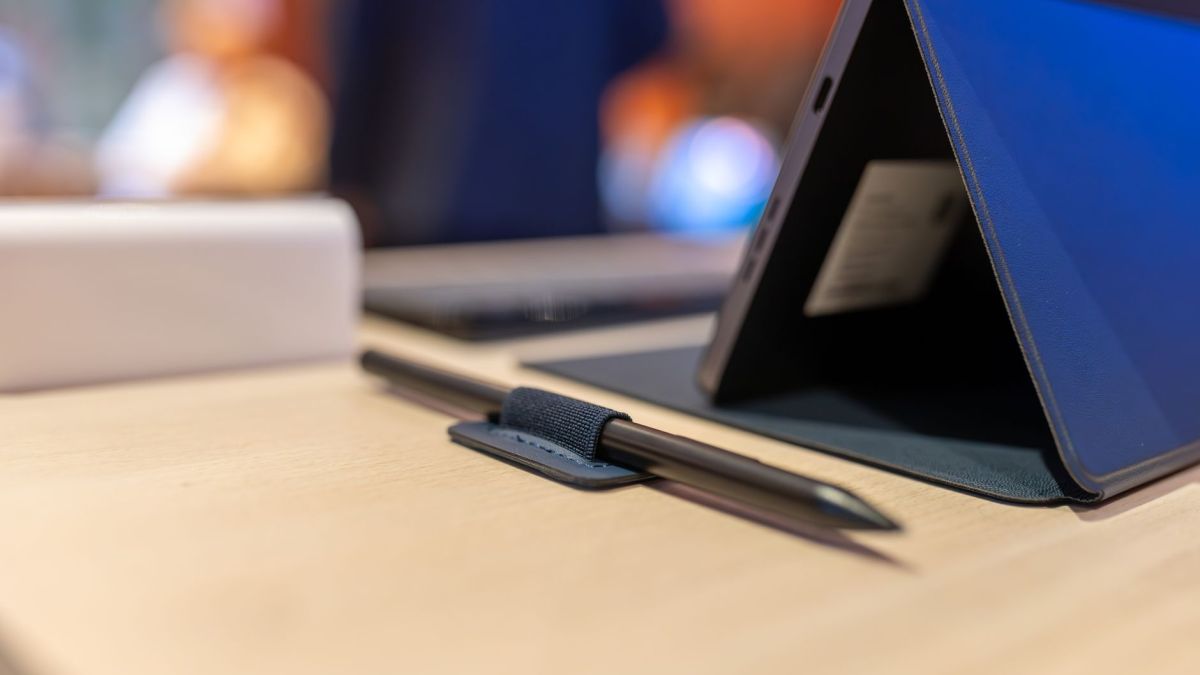 A contemporary workspace featuring a tablet and stylus on a wooden desk, emphasizing modern digital tools.