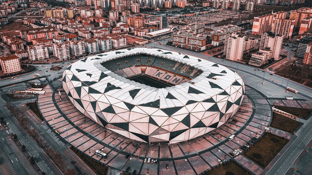 A stunning aerial view of the geometric design of Konya Stadium in Türkiye, showcasing urban architecture.