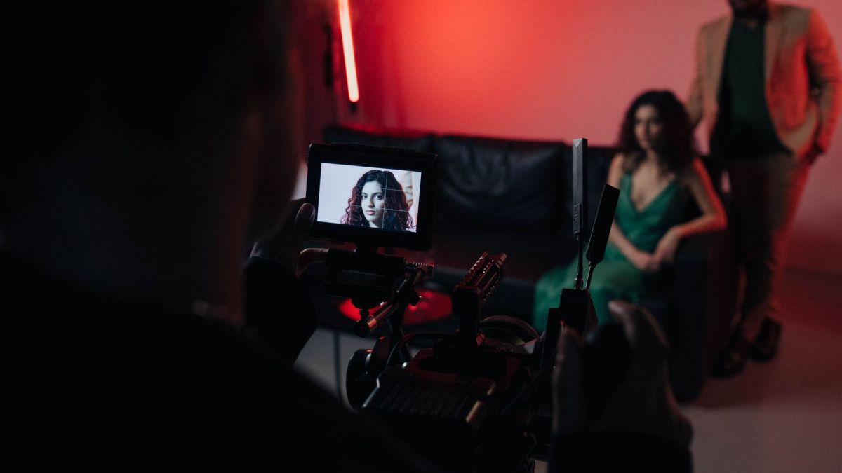 Behind the scenes of a studio filming session focused on actors within a creative setup.