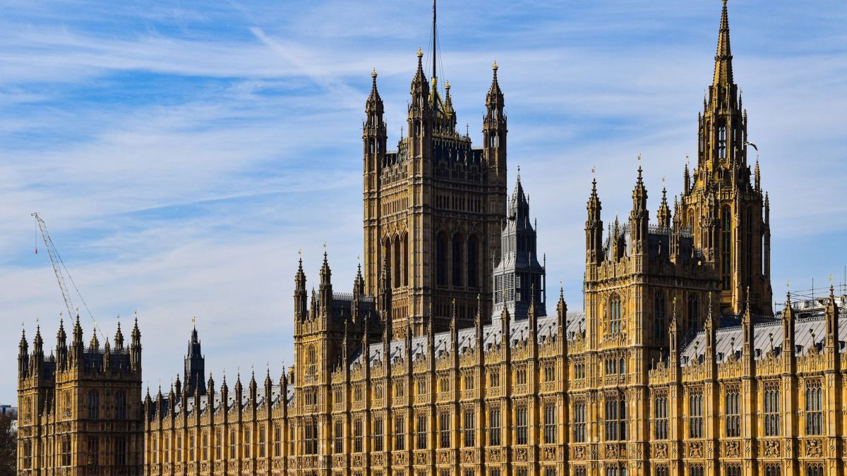 Stunning view of the historic Palace of Westminster in London under a clear blue sky.