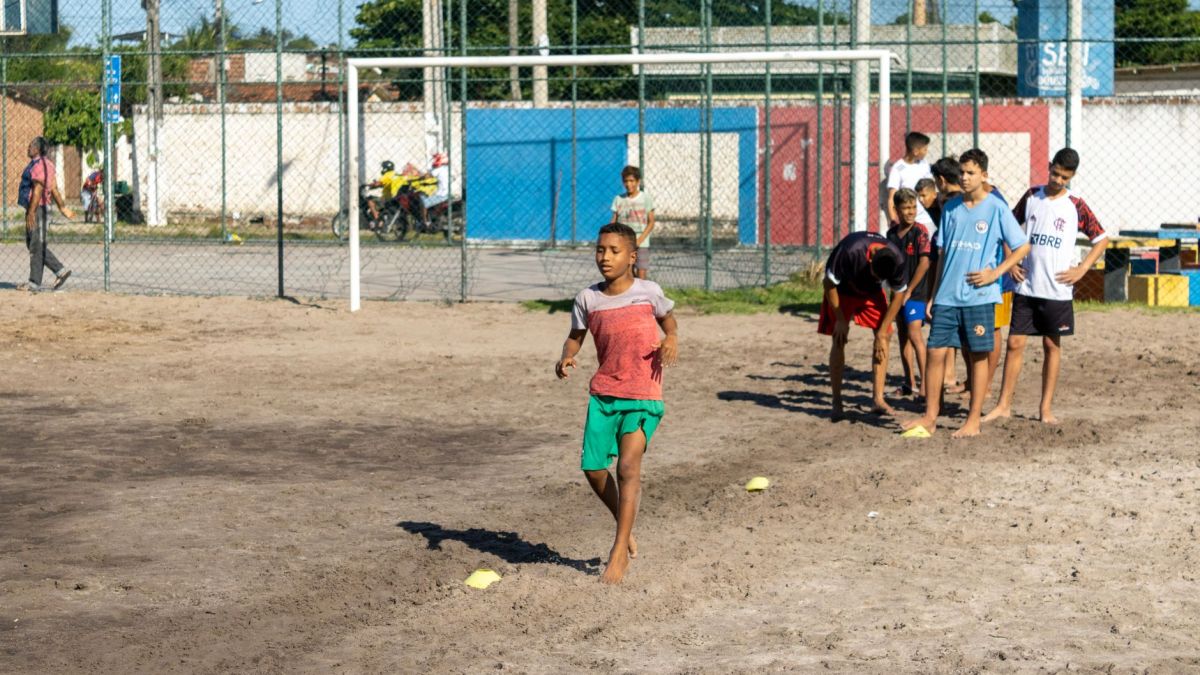 Boys practicing soccer on a sunny day, showcasing teamwork and athletic skills.