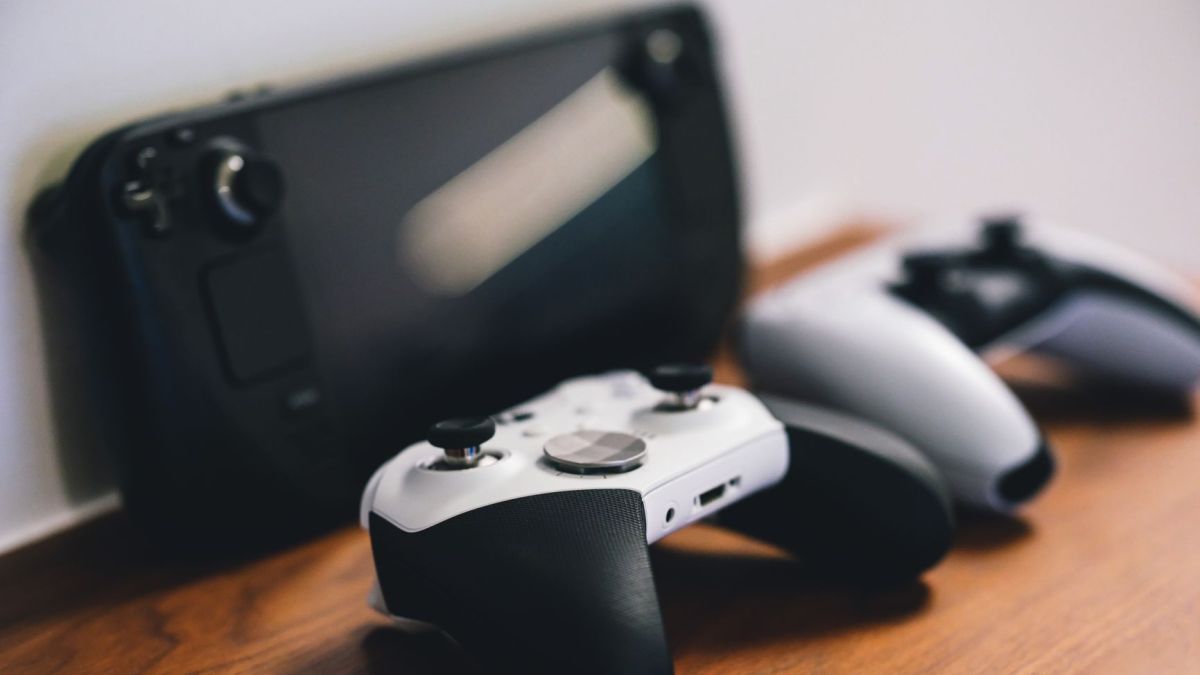 Stylish setup of gaming controllers and console on wooden surface.
