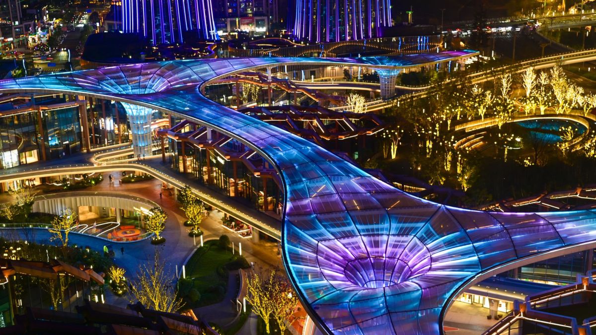 A dazzling night view of futuristic architectural design with glowing lights.