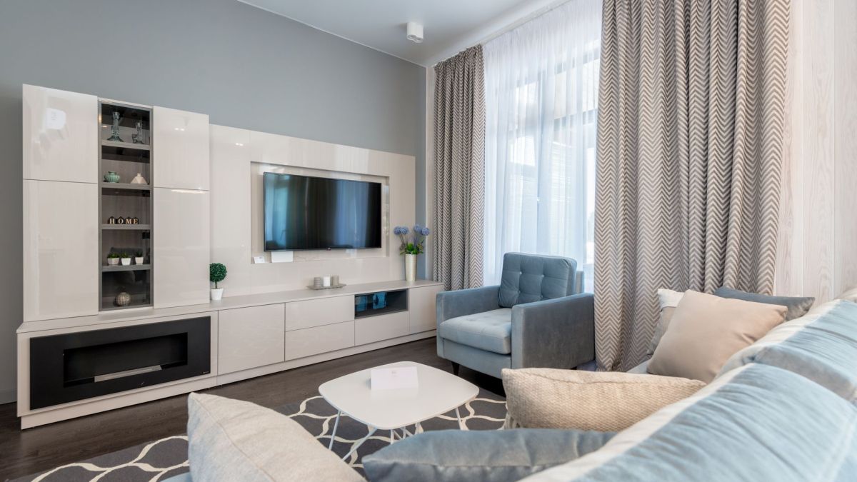 Stylish contemporary living room interior with modern furniture and blue accents.
