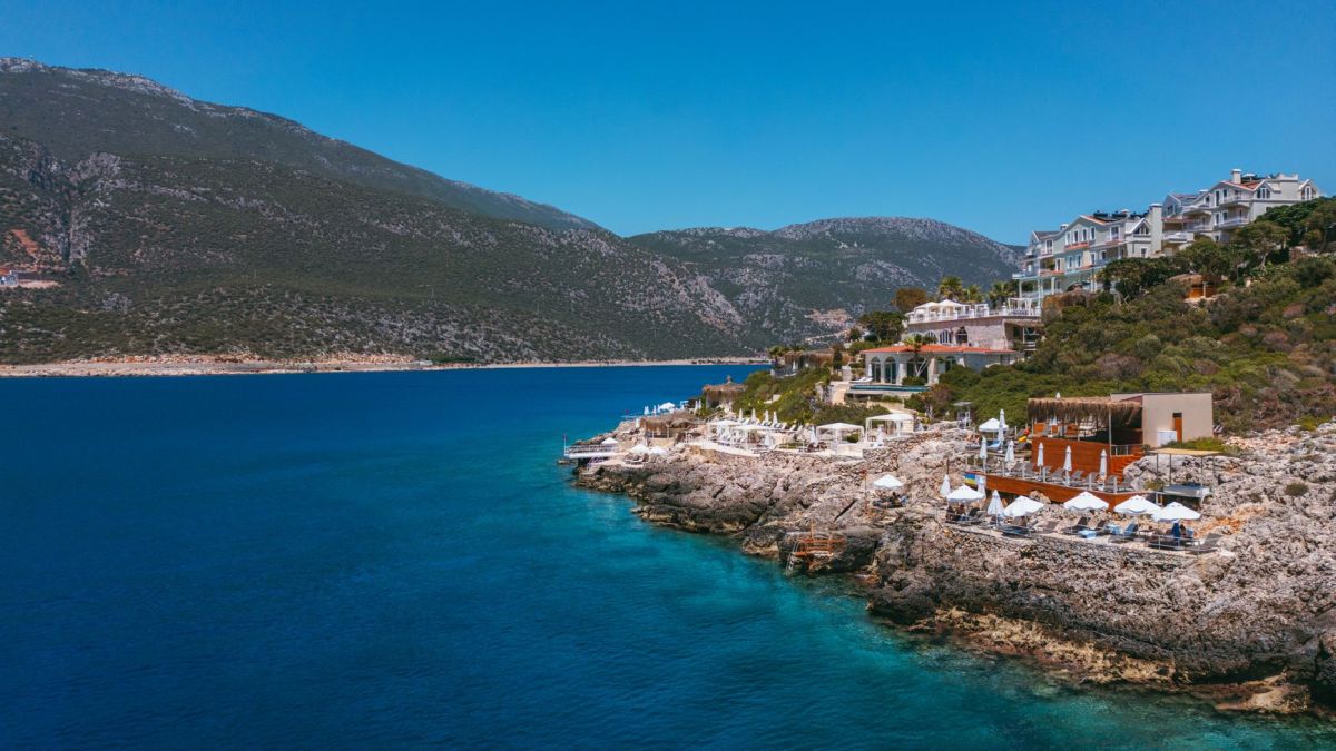 Stunning Mediterranean coast featuring luxury villas and serene blue waters perfect for travel inspiration.
