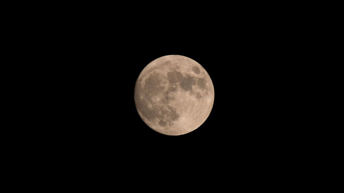 Photograph of the full moon captured against a clear, dark night sky.