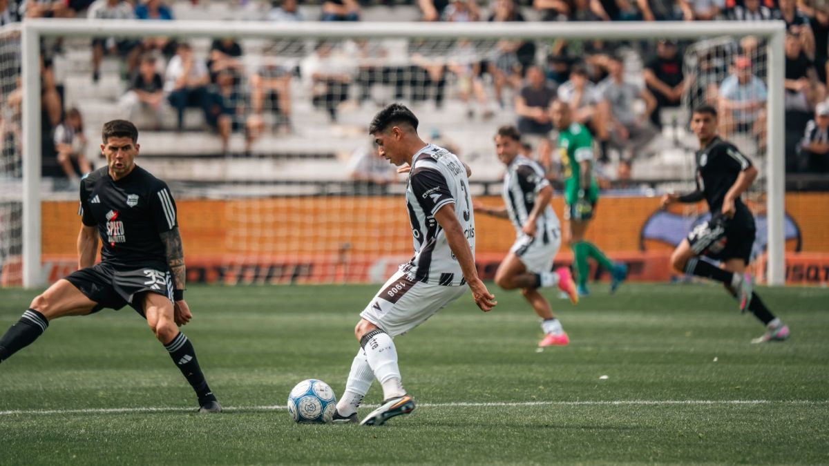 Intense moment during a soccer match with players in motion on the field.