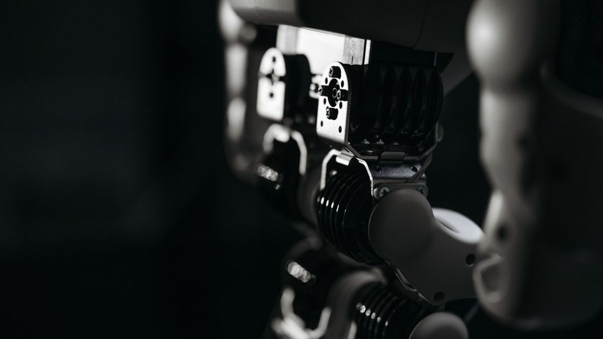 Detailed close-up of a robot's mechanical components, emphasized by moody studio lighting.