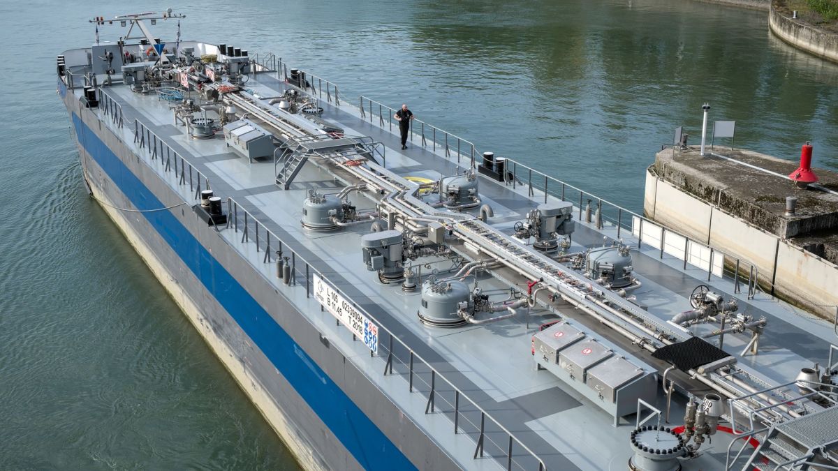 Aerial view of an industrial oil tanker docked at a harbor, showcasing modern maritime technology.