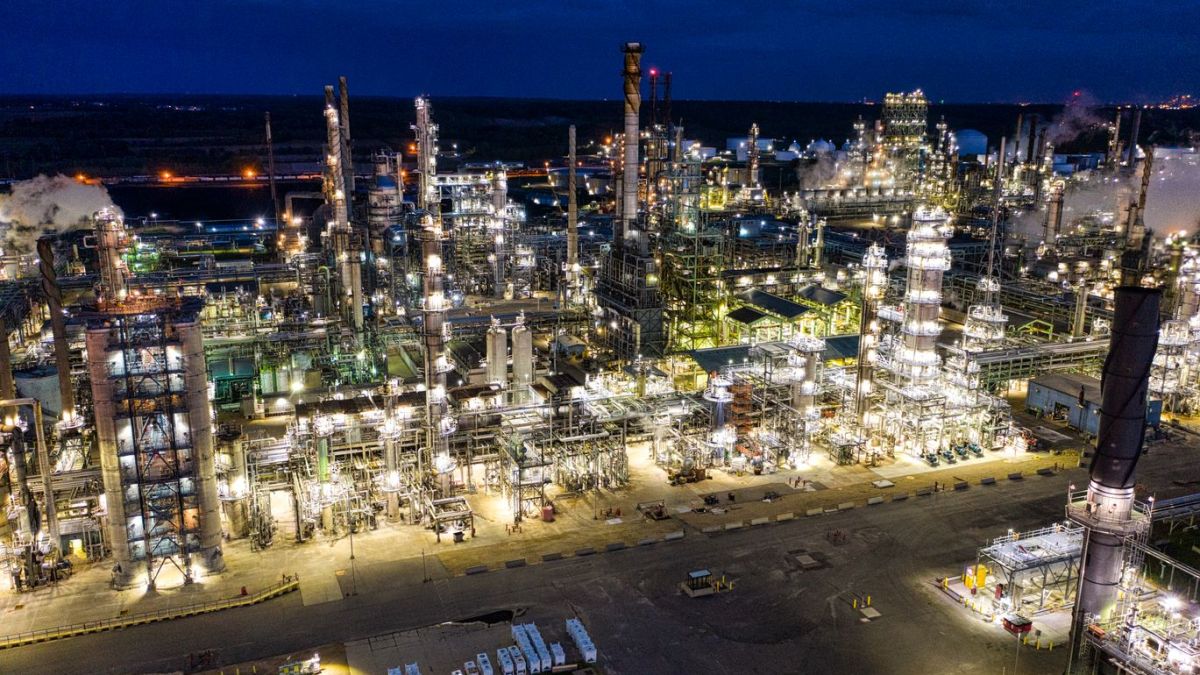 Dramatic aerial shot of an illuminated oil refinery at night in Rosemount, MN.