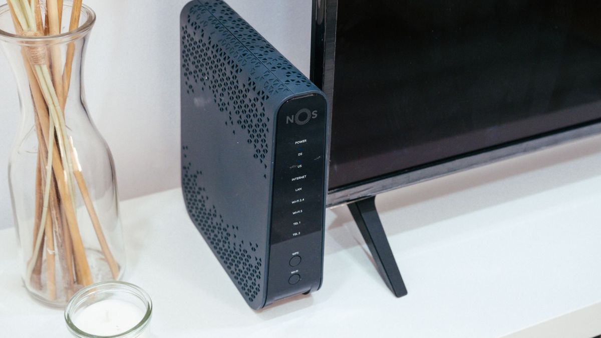 A sleek home technology setup featuring a router, glass decoration, and television.