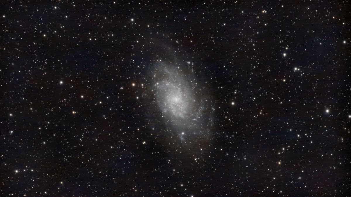 A mesmerizing image of a spiral galaxy surrounded by countless stars in the night sky.