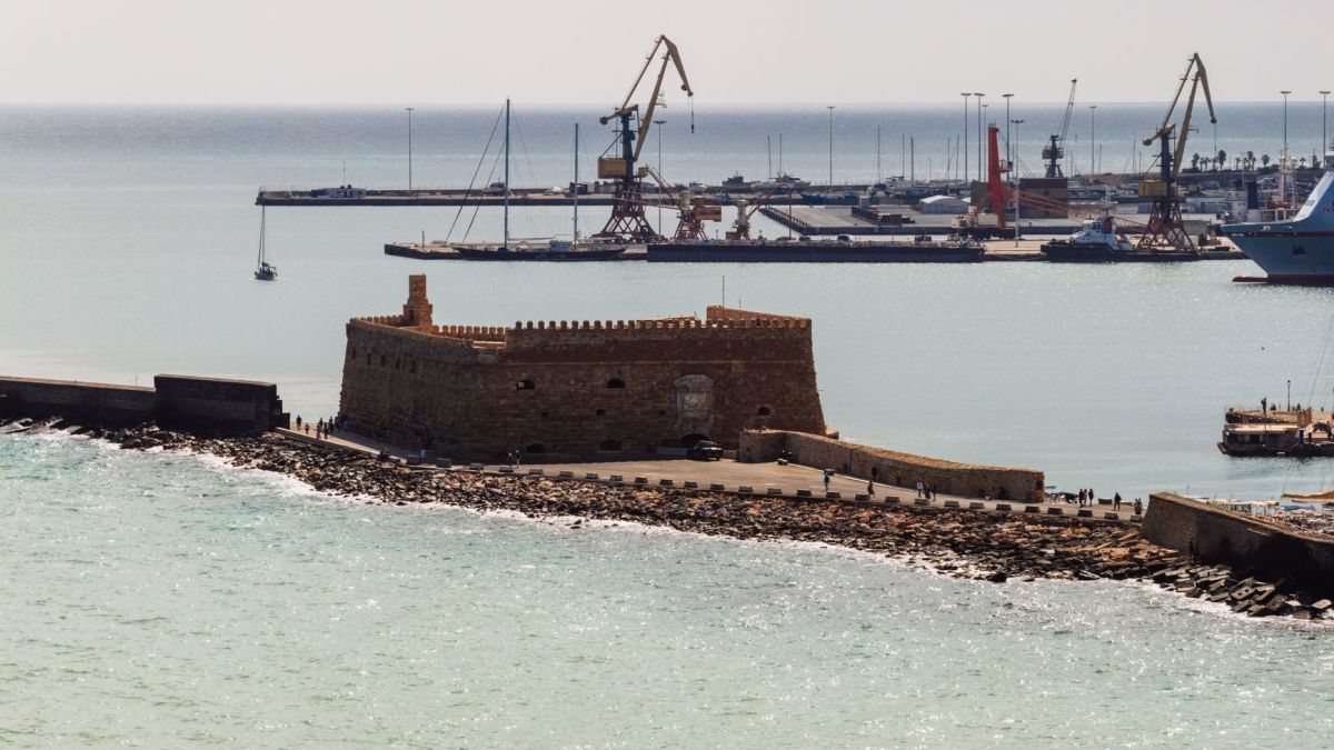 Aerial view of the historic Venetian Fort and harbor cranes in Heraklion, Crete, Greece.